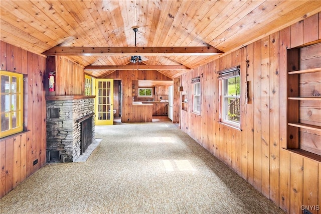 2900 W Lake Rd, Skaneateles, NY 13152 - unfurnished living room with carpet flooring, wooden walls, a stone fireplace, wooden ceiling, and a ceiling fan
