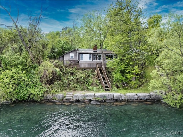2900 W Lake Rd, Skaneateles, NY 13152 - back of house featuring a deck with water view, a chimney, stairs, and a view of trees