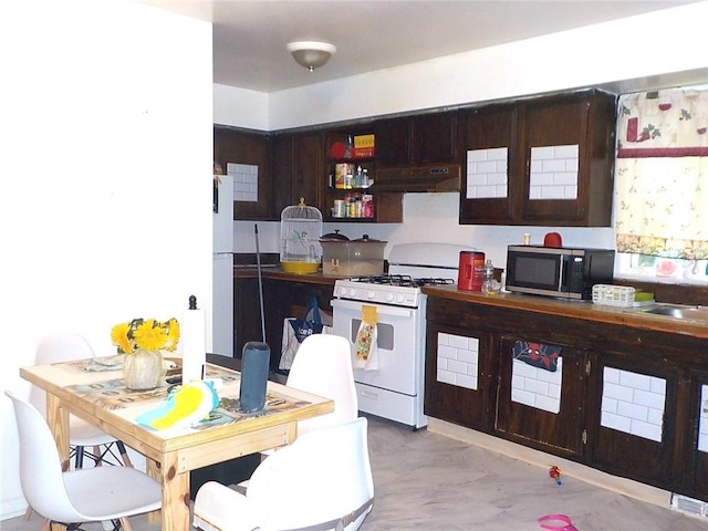 94 Locust St, Rochester, NY 14613 - kitchen with white gas range oven, stainless steel microwave, under cabinet range hood, and a sink