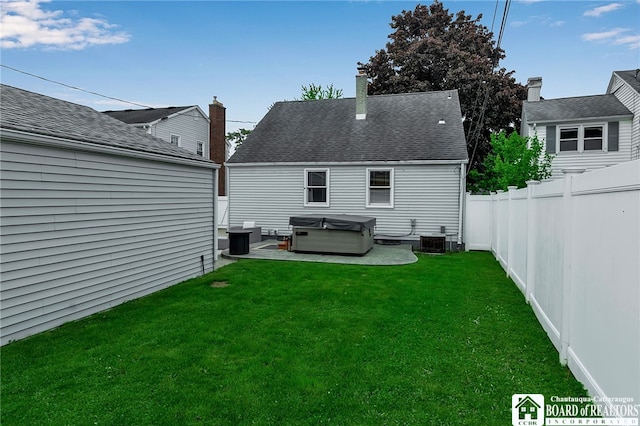 62 Thistle Ave, Tonawanda-Town, NY 14150 - back of property with a hot tub, central air condition unit, a patio area, and roof with shingles
