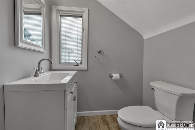 62 Thistle Ave, Tonawanda-Town, NY 14150 - half bathroom featuring toilet, wood finished floors, vaulted ceiling, vanity, and baseboards