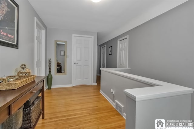 62 Thistle Ave, Tonawanda-Town, NY 14150 - corridor with light wood-style flooring, an upstairs landing, and baseboards