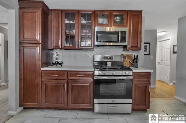 62 Thistle Ave, Tonawanda-Town, NY 14150 - kitchen with appliances with stainless steel finishes, light countertops, baseboards, and backsplash
