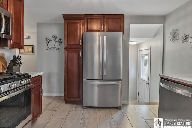 62 Thistle Ave, Tonawanda-Town, NY 14150 - kitchen featuring stainless steel appliances, light countertops, and baseboards