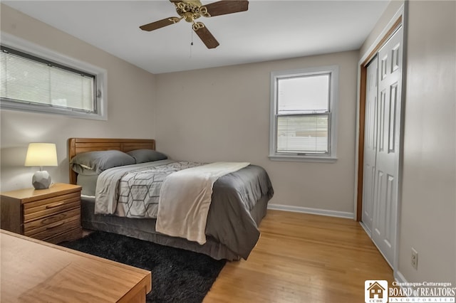 62 Thistle Ave, Tonawanda-Town, NY 14150 - bedroom featuring a closet, baseboards, light wood finished floors, and multiple windows