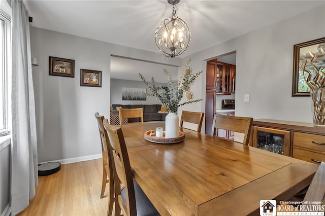 62 Thistle Ave, Tonawanda-Town, NY 14150 - dining space with light wood finished floors, a chandelier, and baseboards