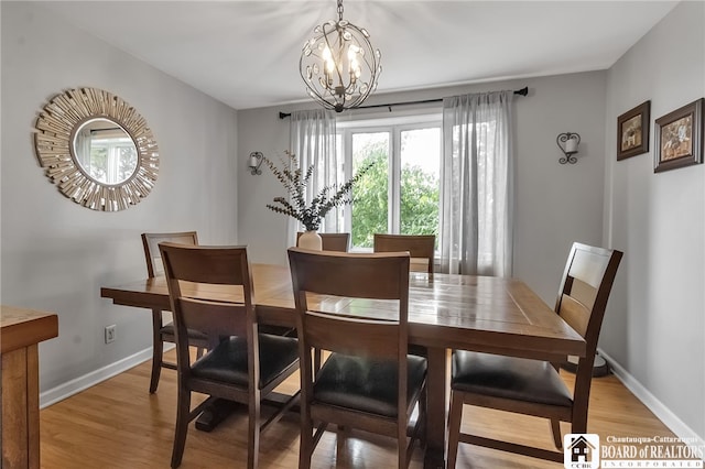 62 Thistle Ave, Tonawanda-Town, NY 14150 - dining space featuring a chandelier, light wood-style flooring, and baseboards