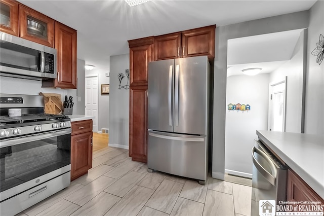 62 Thistle Ave, Tonawanda-Town, NY 14150 - kitchen with stainless steel appliances, light countertops, glass insert cabinets, baseboards, and brown cabinets