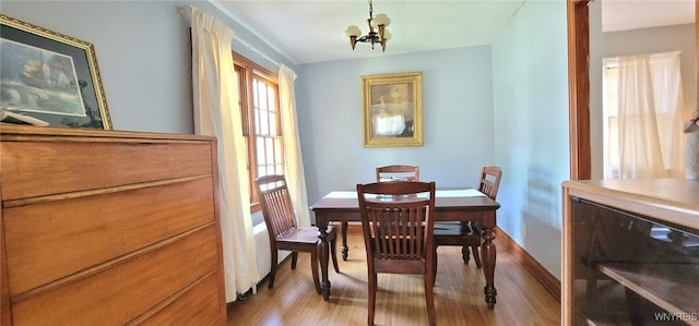 323 Portage Rd, Niagara Falls, NY 14303 - dining area with light wood finished floors and a chandelier