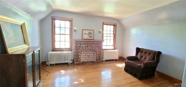 323 Portage Rd, Niagara Falls, NY 14303 - sitting room with radiator heating unit, lofted ceiling, wood finished floors, and baseboards