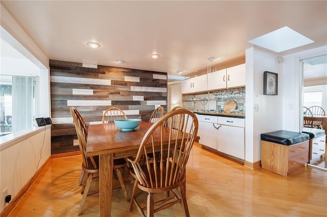 2171 Hansen Point Rd, Torrey, NY 14527 - dining room featuring light wood-style floors, wood walls, and recessed lighting