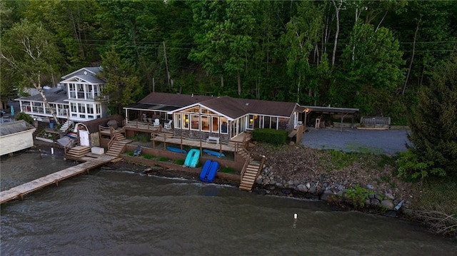 2171 Hansen Point Rd, Torrey, NY 14527 - rear view of house featuring stairs, a deck with water view, a view of trees, and a carport