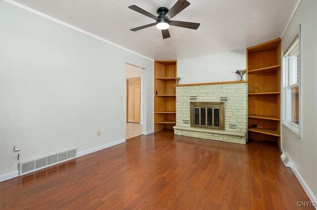 6 Viburnum Pl, New Hartford, NY 13413 - unfurnished living room with ceiling fan, baseboards, built in shelves, and ornamental molding