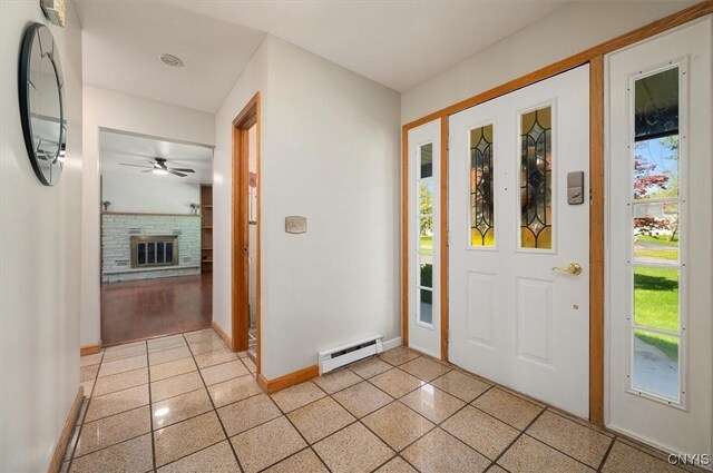 6 Viburnum Pl, New Hartford, NY 13413 - foyer entrance featuring baseboard heating, baseboards, ceiling fan, and a glass covered fireplace