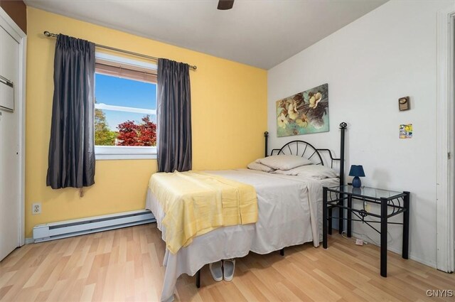 6 Viburnum Pl, New Hartford, NY 13413 - bedroom with baseboard heating, wood finished floors, and baseboards