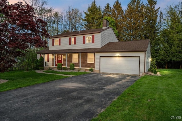 6 Viburnum Pl, New Hartford, NY 13413 - view of front of house with driveway, an attached garage, covered porch, a chimney, and a lawn
