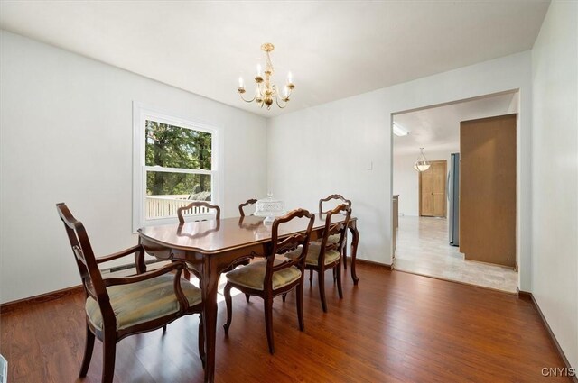 6 Viburnum Pl, New Hartford, NY 13413 - dining area with a chandelier, wood finished floors, and baseboards