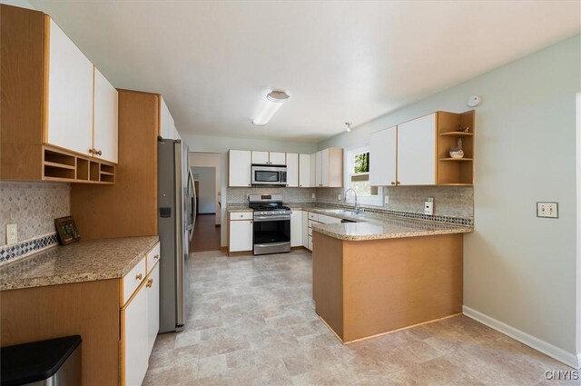 6 Viburnum Pl, New Hartford, NY 13413 - kitchen with appliances with stainless steel finishes, open shelves, a peninsula, and decorative backsplash