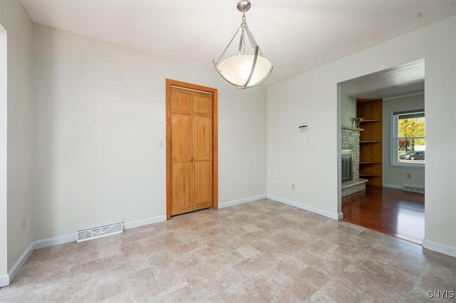 6 Viburnum Pl, New Hartford, NY 13413 - empty room featuring a fireplace, baseboards, and light flooring