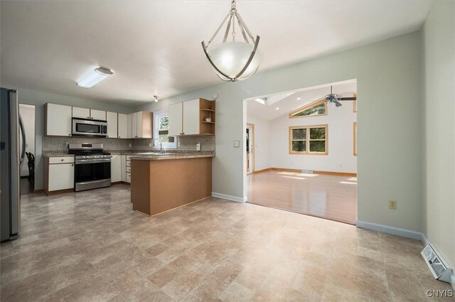 6 Viburnum Pl, New Hartford, NY 13413 - kitchen featuring appliances with stainless steel finishes, open floor plan, healthy amount of natural light, backsplash, and vaulted ceiling