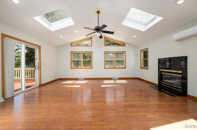 6 Viburnum Pl, New Hartford, NY 13413 - unfurnished living room featuring a skylight, a wall unit AC, a tiled fireplace, vaulted ceiling, and recessed lighting