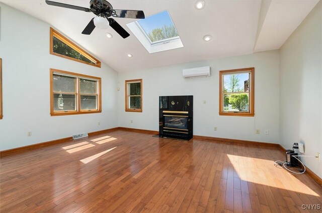 6 Viburnum Pl, New Hartford, NY 13413 - unfurnished living room with a wall mounted AC, a skylight, ceiling fan, lofted ceiling, and hardwood / wood-style floors
