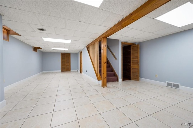 6 Viburnum Pl, New Hartford, NY 13413 - finished basement with stairway, a drop ceiling, baseboards, and light tile patterned floors