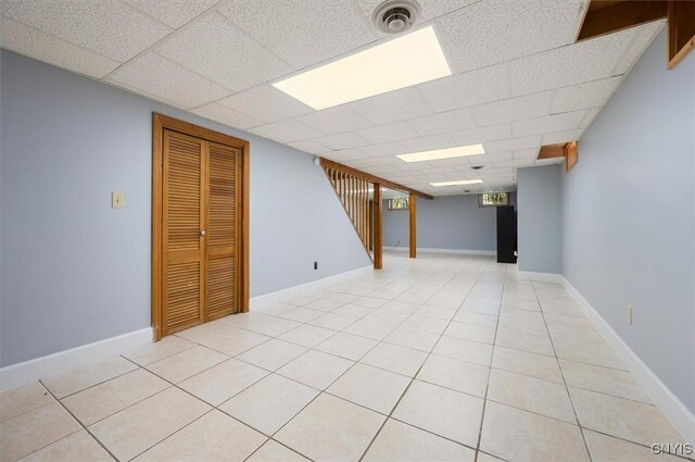6 Viburnum Pl, New Hartford, NY 13413 - basement featuring a paneled ceiling, stairway, and light tile patterned floors