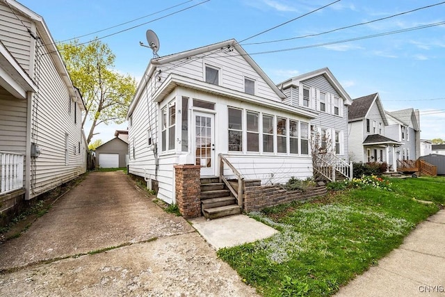 32 E 5th St, Oswego-City, NY 13126 - shotgun-style home featuring entry steps, an outdoor structure, and a garage