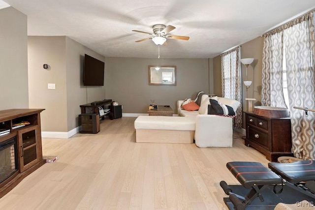 32 E 5th St, Oswego-City, NY 13126 - living area featuring a ceiling fan, wood finished floors, and baseboards