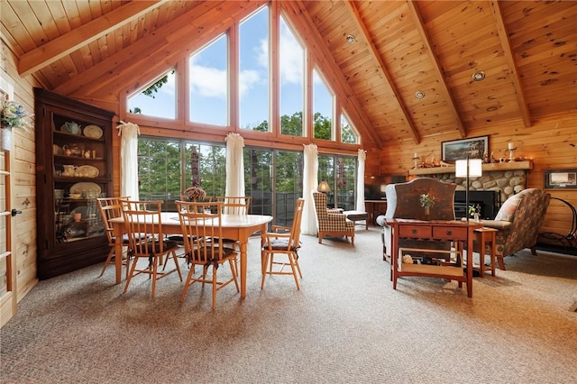 5889 W Bluff Dr, Jerusalem, NY 14478 - carpeted dining area with wooden ceiling with exposed beams, wood walls, high vaulted ceiling, and a stone fireplace