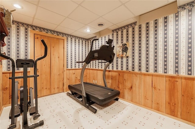 5889 W Bluff Dr, Jerusalem, NY 14478 - workout area with a paneled ceiling, wooden walls, wallpapered walls, and a wainscoted wall