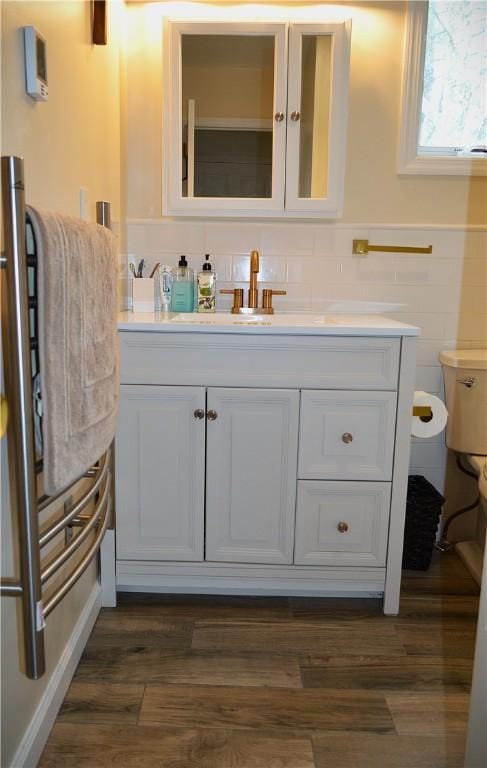 100 Clear Springs Ln, Middletown, NY 12430 - bathroom with vanity, toilet, tile walls, wood finished floors, and wainscoting
