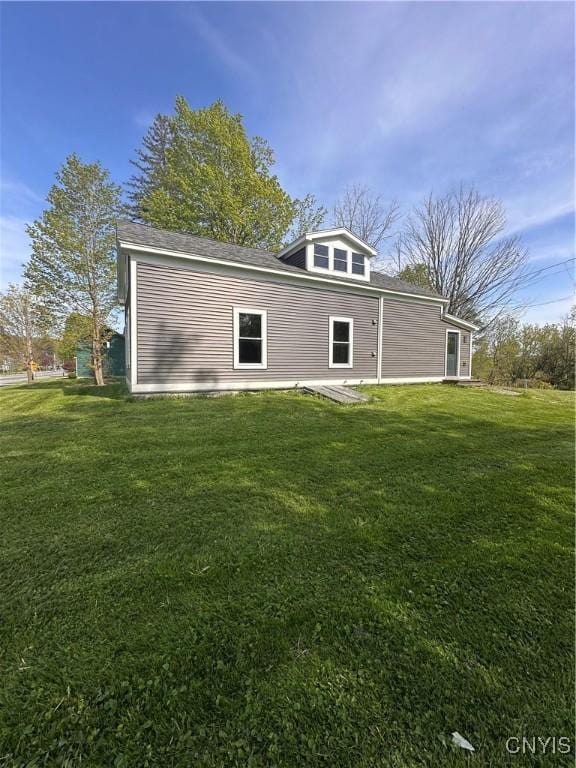 61 W Main St, Eaton, NY 13408 - back of property with a lawn and a patio