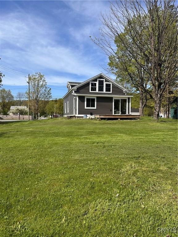 61 W Main St, Eaton, NY 13408 - view of front of home featuring a wooden deck and a front yard