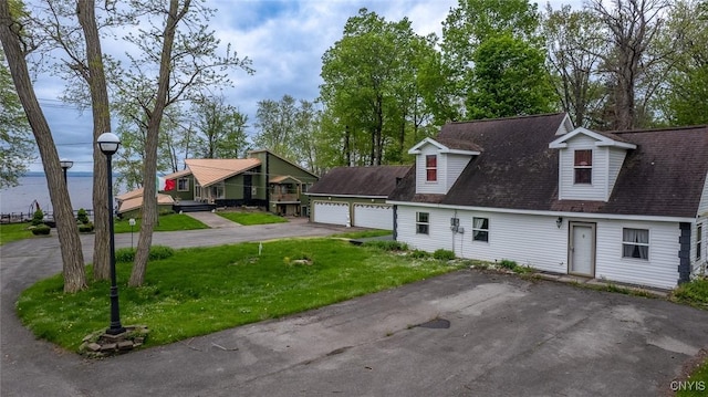 1079 State Route 49, Constantia, NY 13028 - view of front of home with a front yard, driveway, a detached garage, and roof with shingles