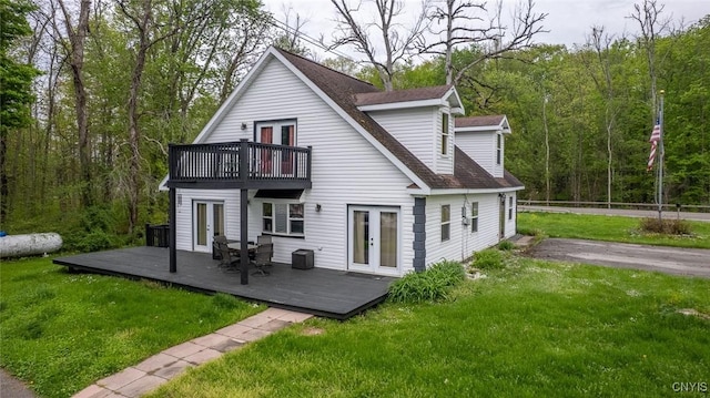 1079 State Route 49, Constantia, NY 13028 - back of property featuring french doors, a deck, a yard, a forest view, and roof with shingles