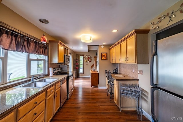 1079 State Route 49, Constantia, NY 13028 - kitchen with appliances with stainless steel finishes, a sink, dark wood finished floors, tasteful backsplash, and baseboards