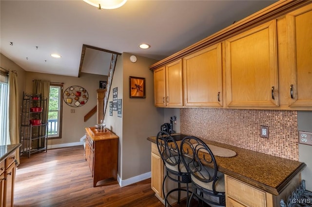 1079 State Route 49, Constantia, NY 13028 - kitchen featuring dark wood-style floors, baseboards, tasteful backsplash, recessed lighting, and brown cabinetry