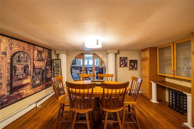 1079 State Route 49, Constantia, NY 13028 - dining space featuring a baseboard radiator, dark wood-type flooring, and a textured ceiling