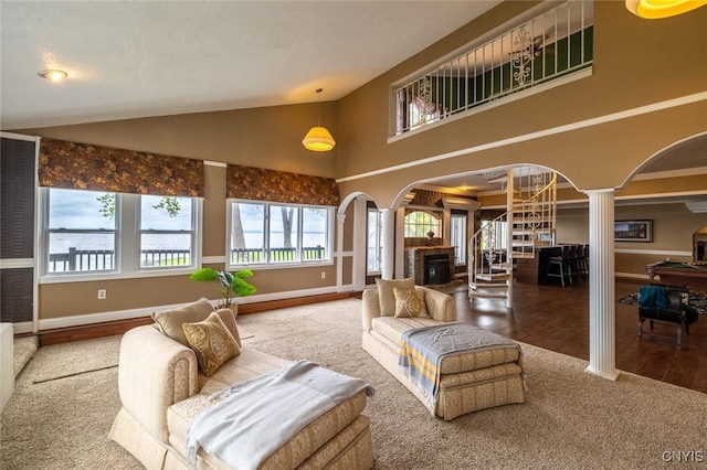 1079 State Route 49, Constantia, NY 13028 - carpeted living room featuring decorative columns, arched walkways, lofted ceiling, baseboards, and wood finished floors