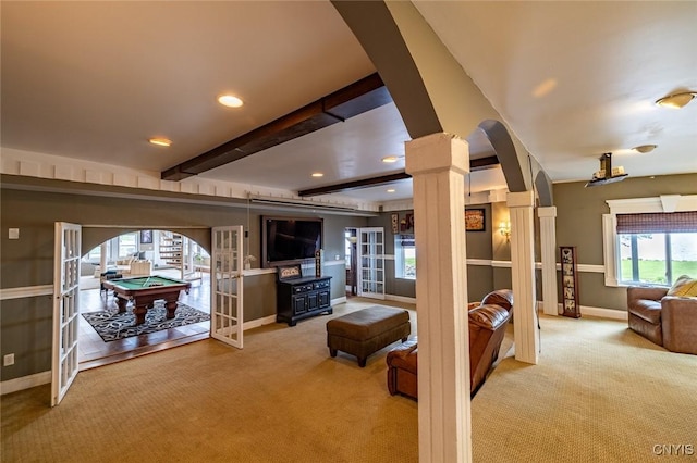 1079 State Route 49, Constantia, NY 13028 - carpeted living area with french doors, decorative columns, baseboards, arched walkways, and beamed ceiling