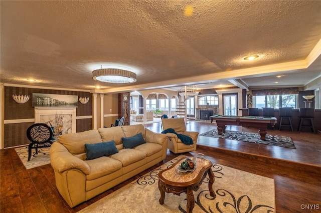 1079 State Route 49, Constantia, NY 13028 - living room featuring a textured ceiling, billiards table, hardwood / wood-style floors, and ornate columns