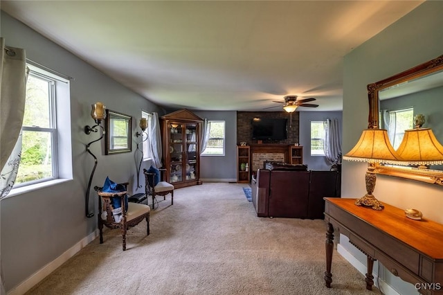 1079 State Route 49, Constantia, NY 13028 - carpeted living area featuring a brick fireplace, a ceiling fan, and baseboards