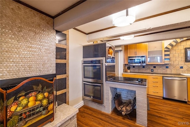 1079 State Route 49, Constantia, NY 13028 - kitchen with appliances with stainless steel finishes, ornamental molding, dark wood-type flooring, tasteful backsplash, and glass insert cabinets