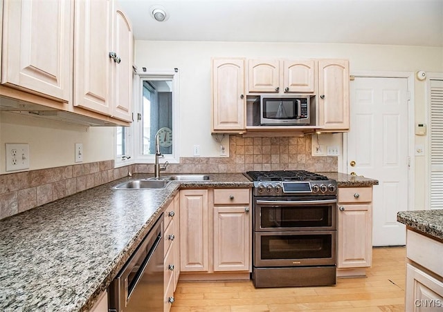 4951 Ravine Rd, Manlius, NY 13066 - kitchen featuring stainless steel appliances, a sink, light brown cabinets, and light wood-style floors