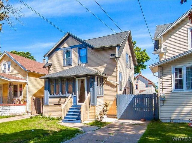 18 Rounds Ave, Buffalo, NY 14215 - view of front of home featuring a gate, a front lawn, a shingled roof, and entry steps