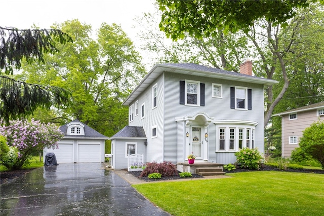 540 List Ave, Irondequoit, NY 14617 - view of front of property with an outbuilding, a chimney, a detached garage, and a front lawn