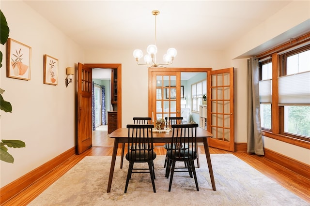 540 List Ave, Irondequoit, NY 14617 - dining room with wood finished floors, baseboards, a chandelier, and french doors