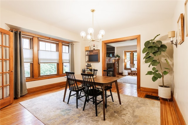 540 List Ave, Irondequoit, NY 14617 - dining space featuring wood finished floors, a chandelier, and baseboards